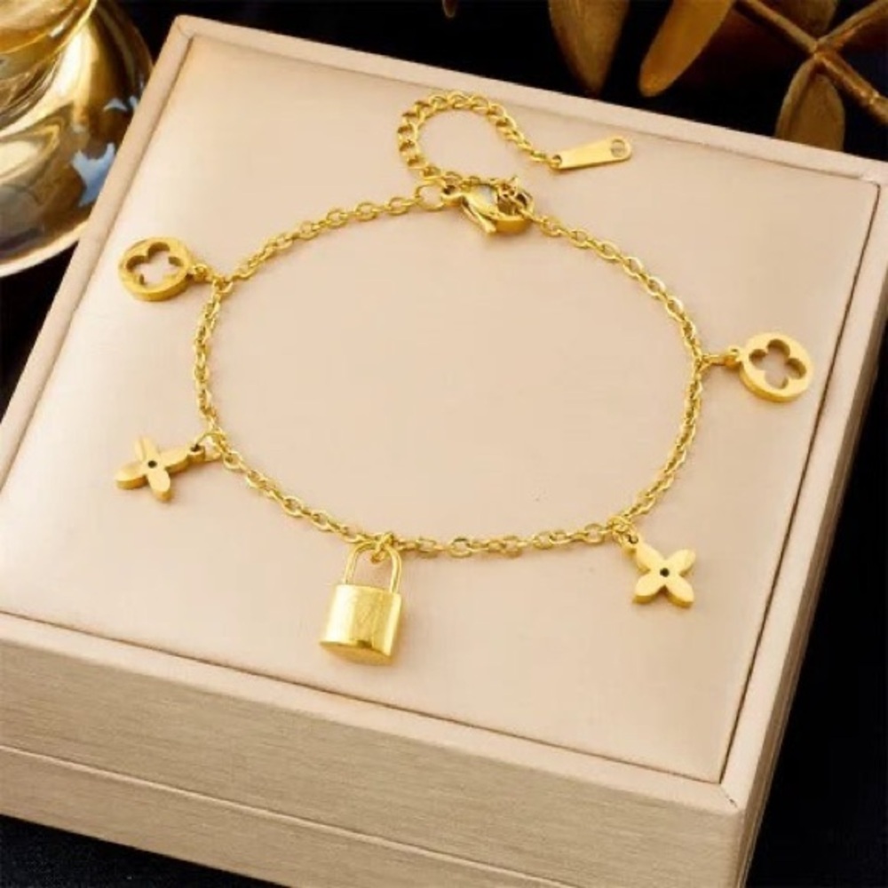 18K Gold Designer Charm Bracelet with Lock and Flower Accents - Picture 3 of 8